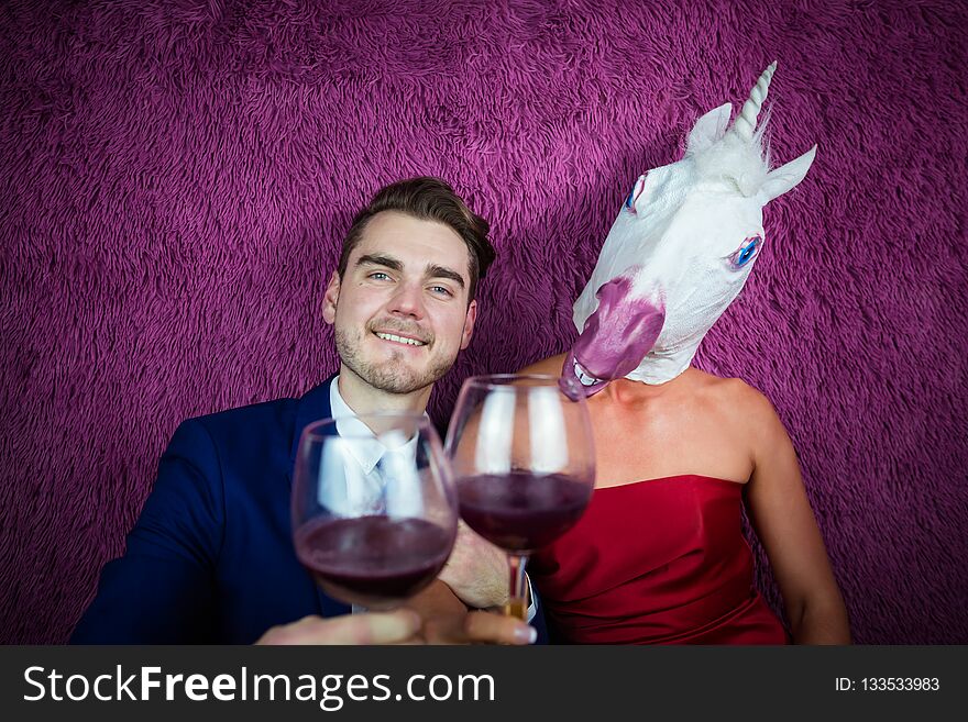 Portrait of strange couple on purple background