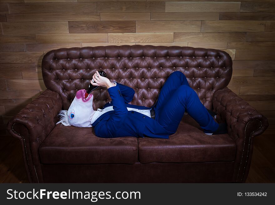 Funny Unicorn In Elegant Suit Lies On Sofa