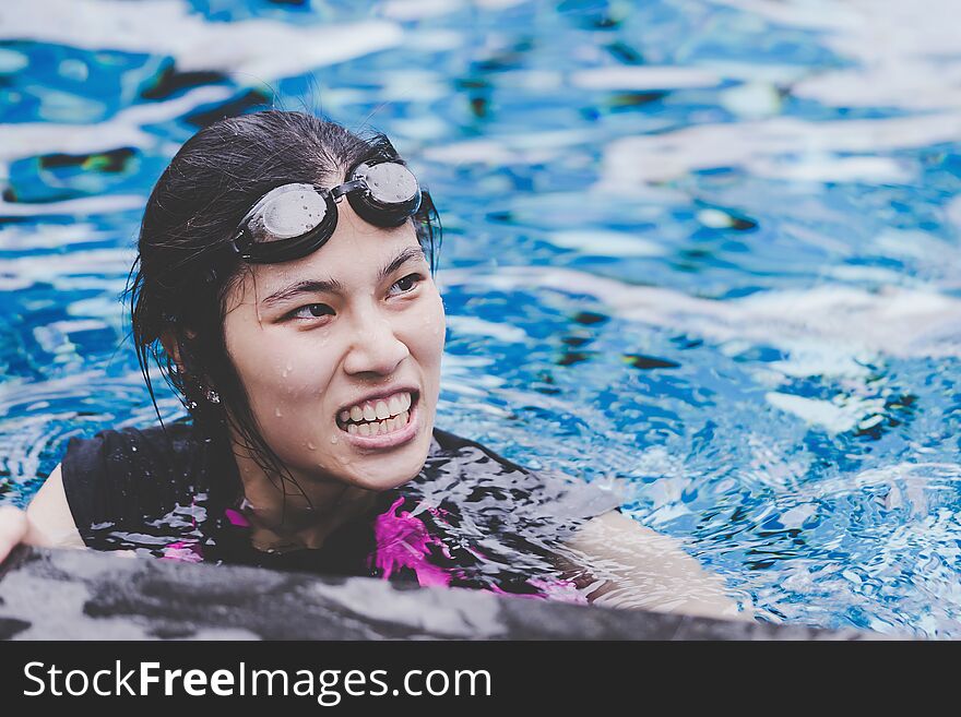 Asian girl swimming pool with copy space