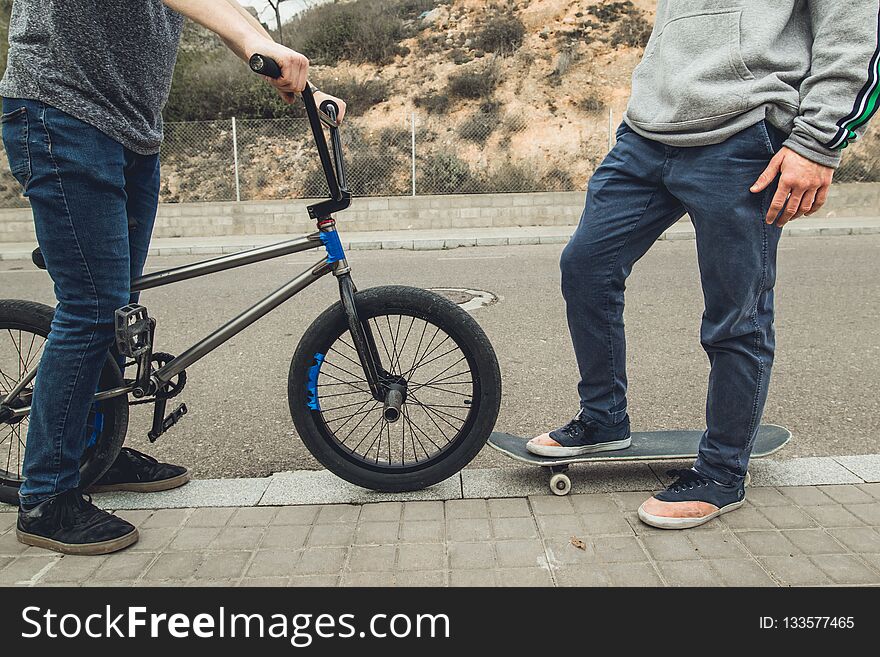 Young people with skateboard and bmx bike. Extreme urban sports concept