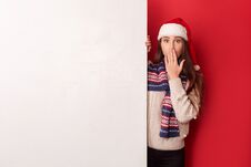 Freestyle. Young Woman Wearing Scarf And Santa Hat Standing Isolated On Red With White Board Covering Mouth Shocked Stock Photos