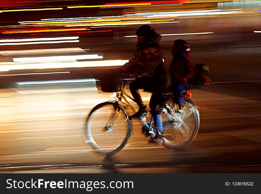 Rushhour With Cyclists And Child At Night