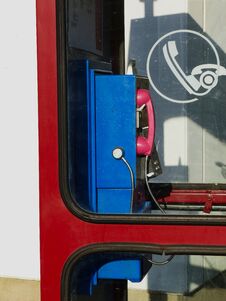 Retro Style Blue Land Line Public Telephone In Red Booth Royalty Free Stock Photos