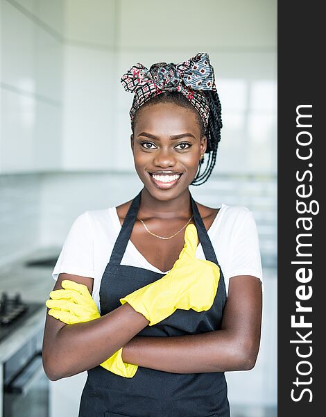 Young African Woman In Yellow Gloves Who Showing Thumb Up At Home