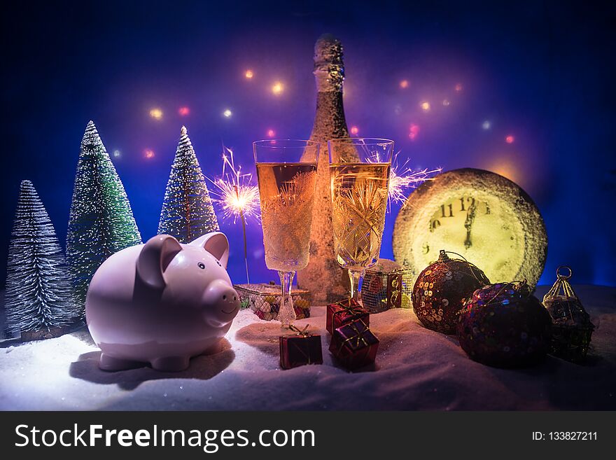 Two glasses of champagne with Christmas decoration. Traditional winter holiday alcohol drink in snow with creative New Year artwork. Copy space. Selective focus