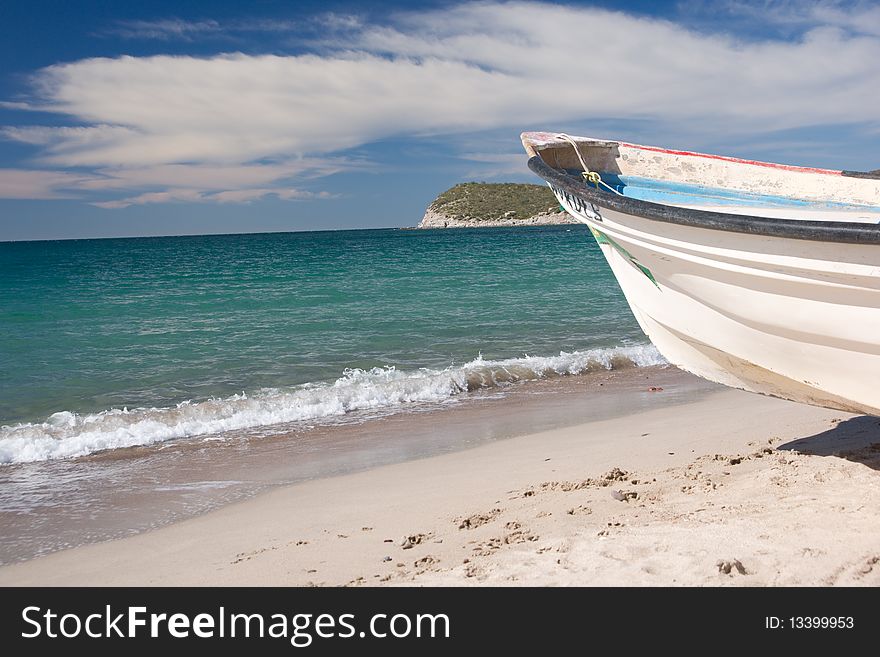 The prow of a fishing boat on the beach looks out to the sea. The prow of a fishing boat on the beach looks out to the sea