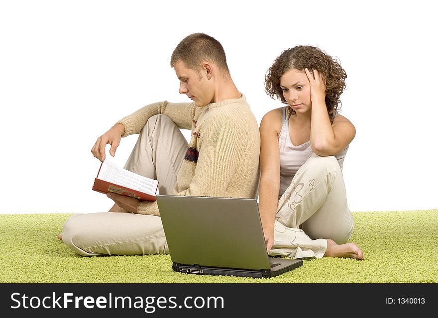 Isolated on white young couple on green carpet with laptop and book