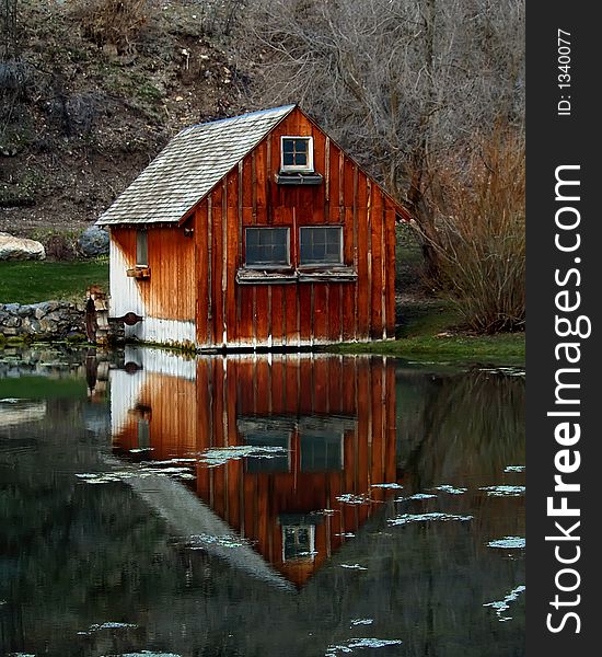 Old mill building and pond in early spring. Old mill building and pond in early spring.