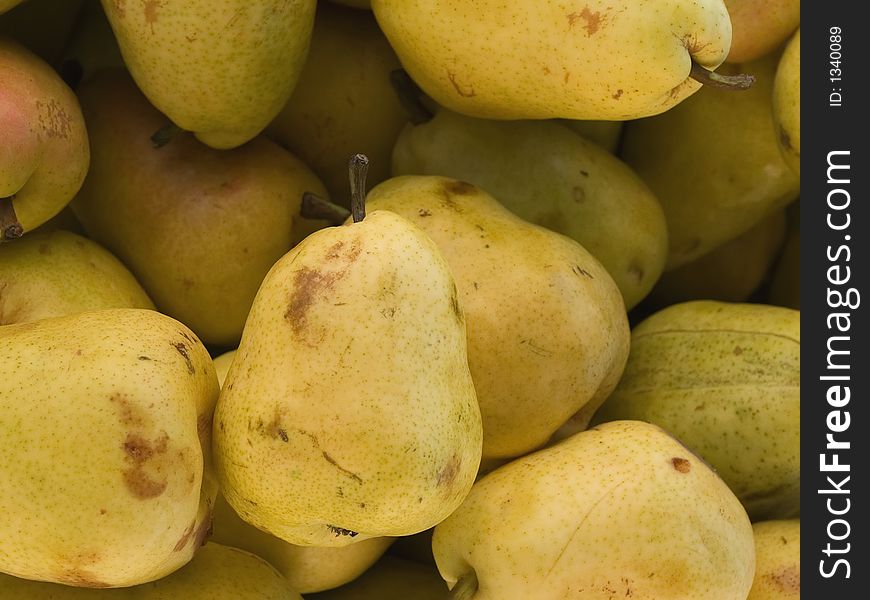 Box of pears for sale at a farmers market.