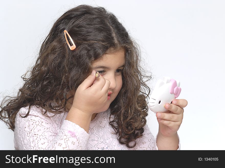 Little girl doing make-up in white background. Little girl doing make-up in white background