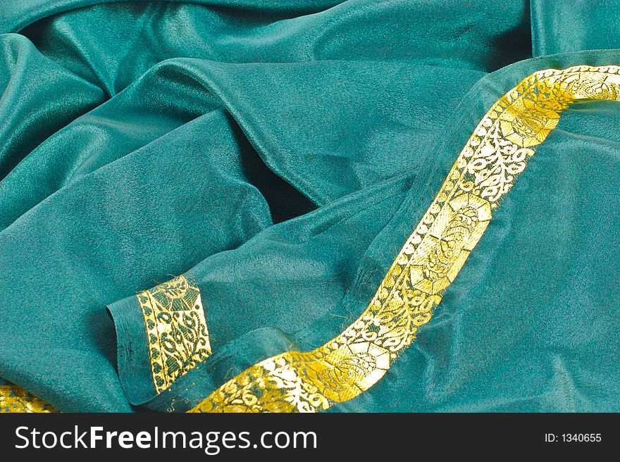 Scrunched up green satin fabric with a gold border. Scrunched up green satin fabric with a gold border