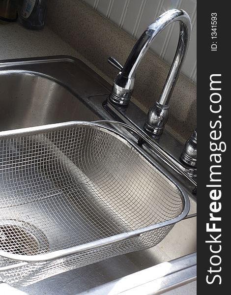 Shiny chrome kitchen sink with strainer. Shiny chrome kitchen sink with strainer