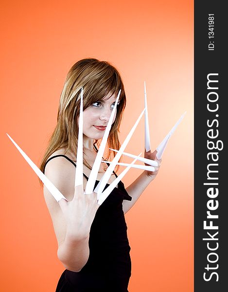 Funny looking cute girl poses with scissor fingers made out of paper - Freddy Kruger style