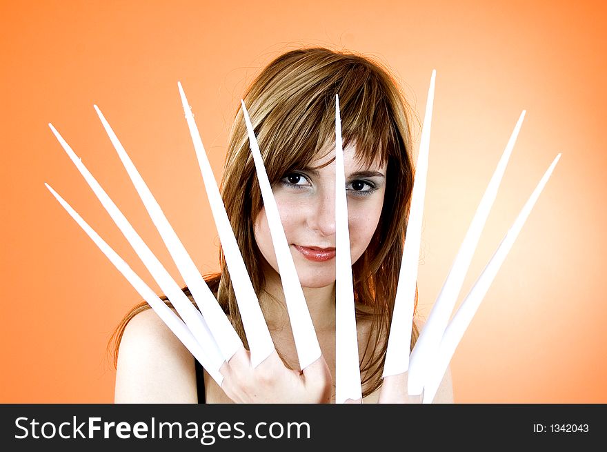 Funny looking cute girl poses with scissor fingers made out of paper - Freddy Kruger style