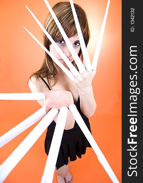 Funny looking cute girl poses with scissor fingers made out of paper - Freddy Kruger style