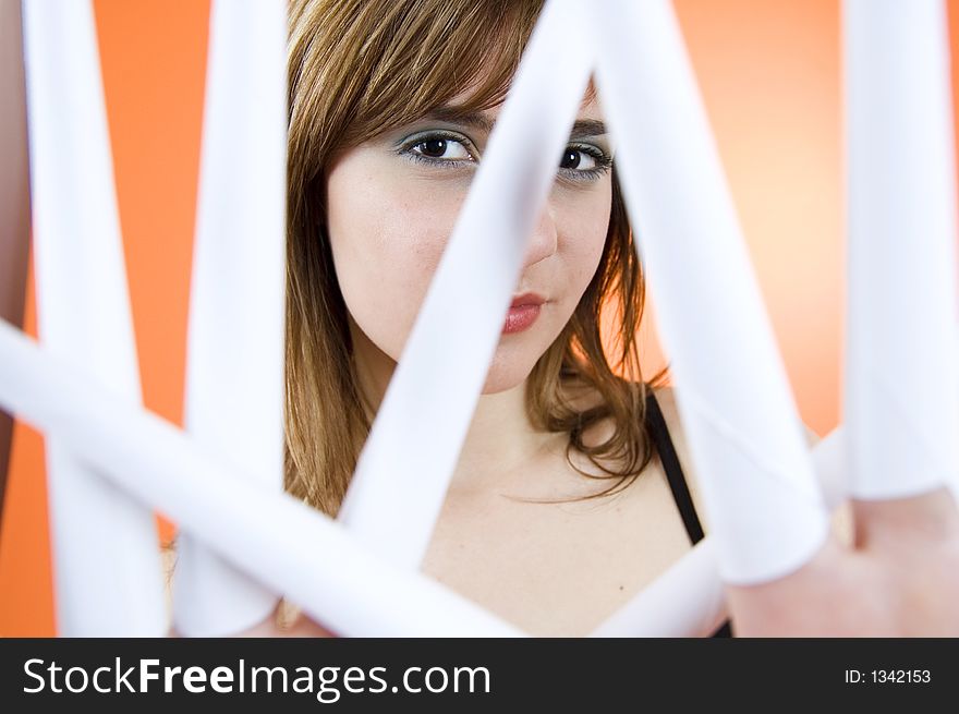 Funny looking cute girl poses with scissor fingers made out of paper - Freddy Kruger style