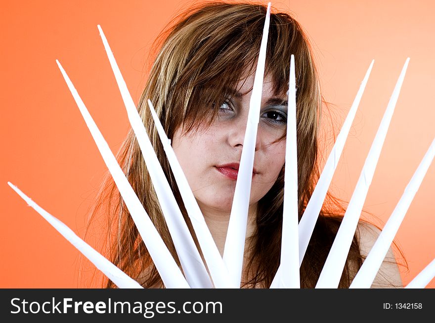 Funny looking cute girl poses with scissor fingers made out of paper - Freddy Kruger style