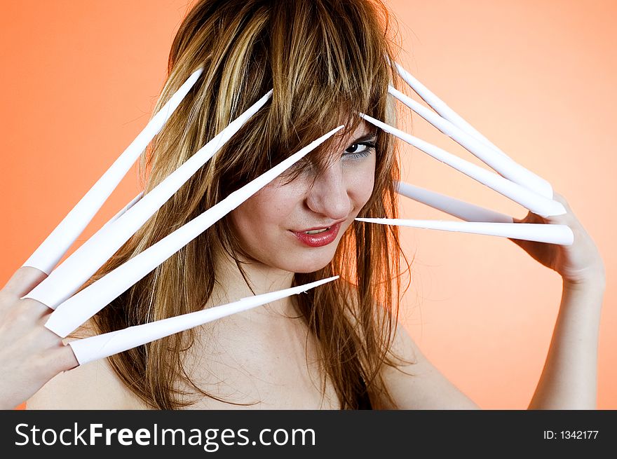 Funny looking cute girl poses with scissor fingers made out of paper - Freddy Kruger style