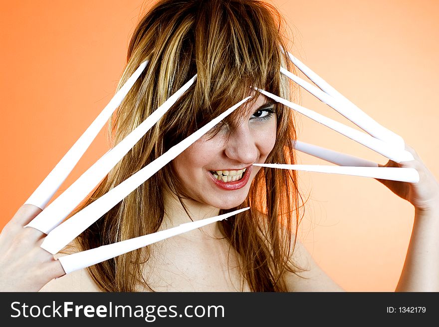 Funny looking cute girl poses with scissor fingers made out of paper - Freddy Kruger style