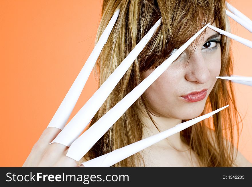 Funny looking cute girl poses with scissor fingers made out of paper - Freddy Kruger style