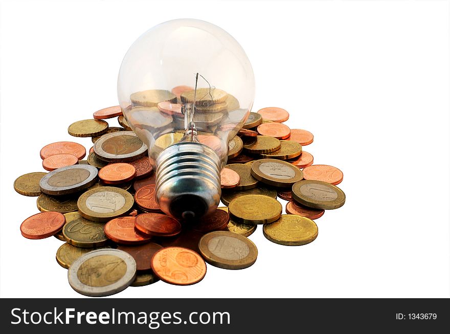 A lightbulb on some coins. A lightbulb on some coins