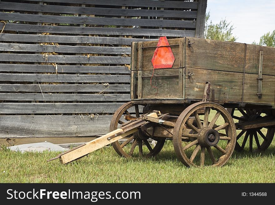 Weathered corn crib and old farm wagon. Weathered corn crib and old farm wagon