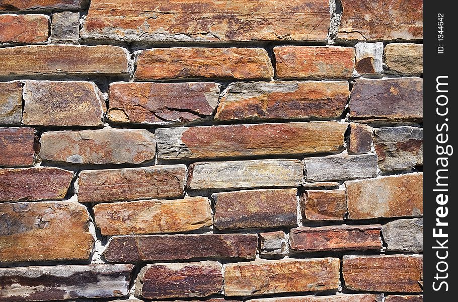 Weathered colorful stone wall - texture background