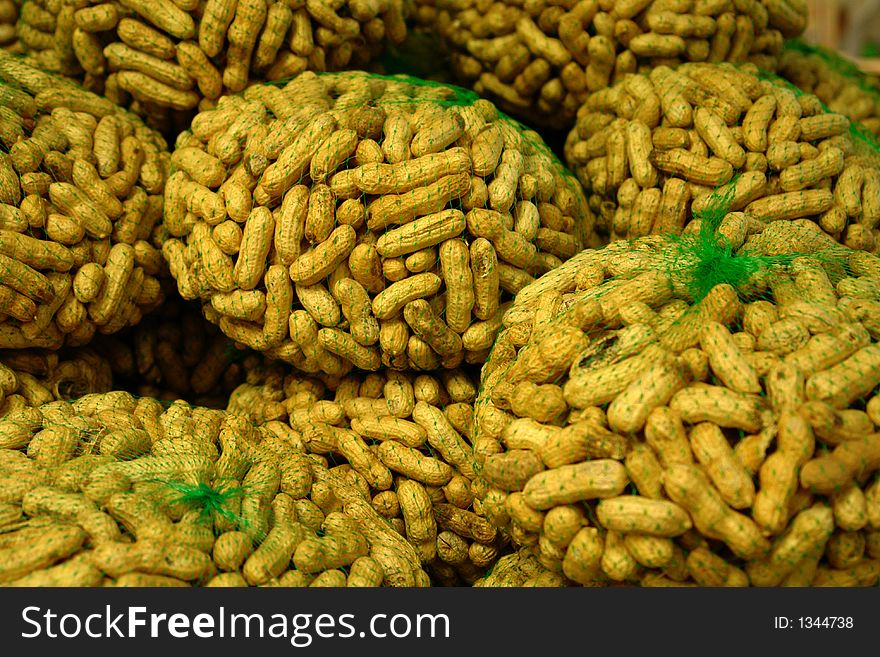 Peanuts on display in green nets