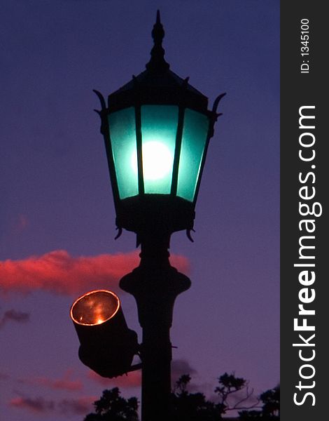 Lit streetlamp at sunset. Argentine. Lit streetlamp at sunset. Argentine
