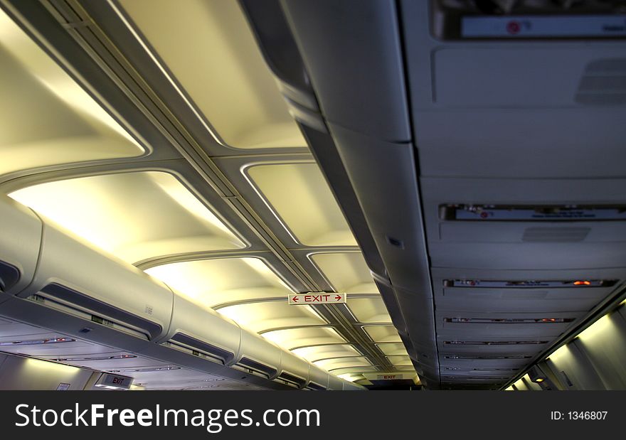 Inside of an airplane showing ceiling lines and lights. Inside of an airplane showing ceiling lines and lights
