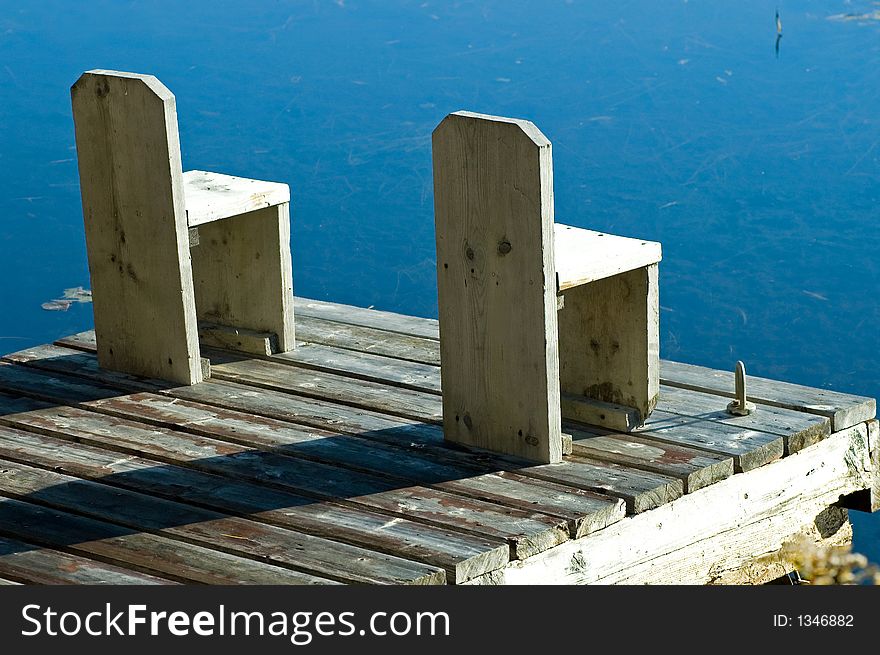 A cottage dock on a lovely clear smooth lake, Muskoka, Ontario, Canada. A cottage dock on a lovely clear smooth lake, Muskoka, Ontario, Canada.