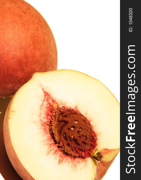 Half and whole peach with seed in