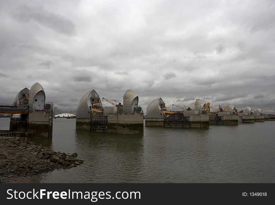 Thames barrier the millennium dome can be seen in the gap between two of the gates woolwich docklands london city england taken in september 2006