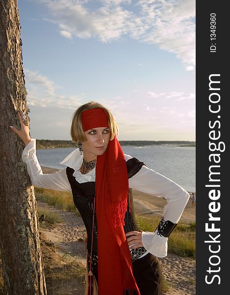 Pirate girl waiting for her ship on a beach