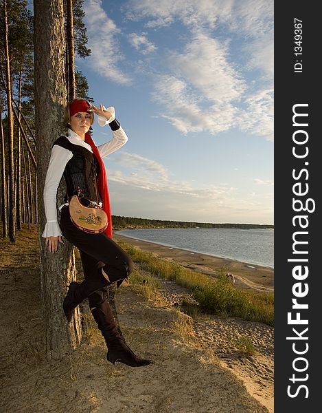 Pirate girl waiting for her ship on a beach