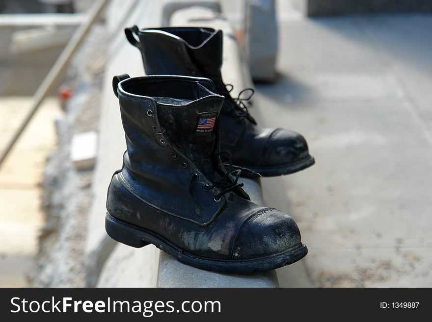 Pair of old boots sitting beside construction site. Pair of old boots sitting beside construction site