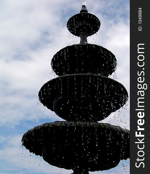 Fountain with water droplets suspended in motion, set against sky. Fountain with water droplets suspended in motion, set against sky