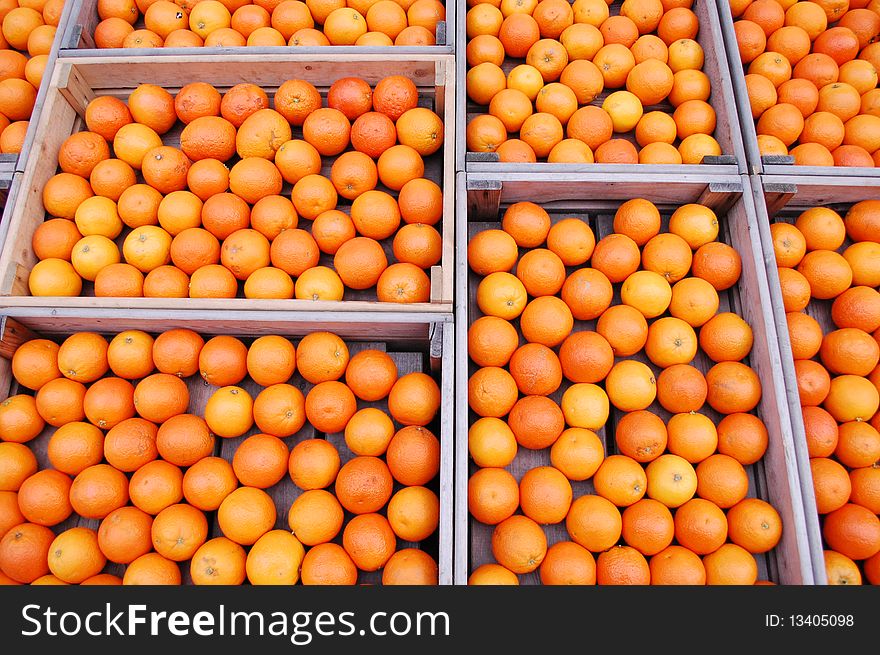 A lot of mandarines in boxes on the market. A lot of mandarines in boxes on the market