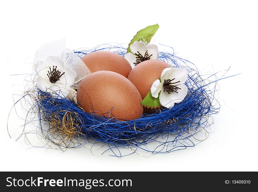 Three eggs in a blue nest on a white background. Three eggs in a blue nest on a white background