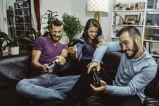 Happy Excited Friends Playing Video Games At Home Together And Having Fun Royalty Free Stock Photos Happy Excited Friends Playing Video Games At Home Together And Having Fun Royalty Free Stock Photos
