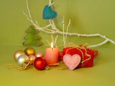 Decorative Seasonal Composition Of A Burning Candle, Felt Hearts, Christmas-tree Balls, Christmas Decor, Romantic Interior Stock Photo