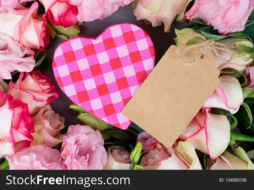 Rose fresh flowers bouquet on gray table from above with gift box and paper note, flat lay scene with copy space. Rose fresh flowers bouquet on gray table from above with gift box and paper note, flat lay scene with copy space