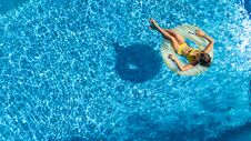 Aerial Drone View Of Little Girl In Swimming Pool From Above, Kid Swims On Inflatable Ring Donut , Child Has Fun In Blue Water Stock Photography Aerial Drone View Of Little Girl In Swimming Pool From Above, Kid Swims On Inflatable Ring Donut , Child Has Fun In Blue Water Stock Photography