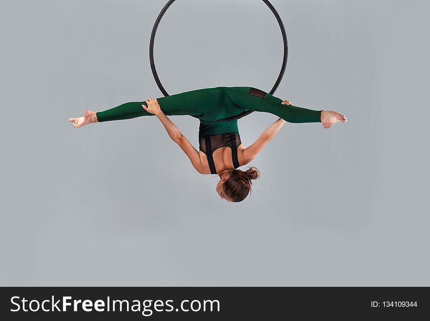 A female gymnast performing exercises on an air ring hoop