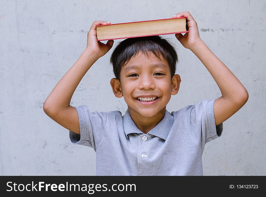 Asian Child Feel Happy with a Book.