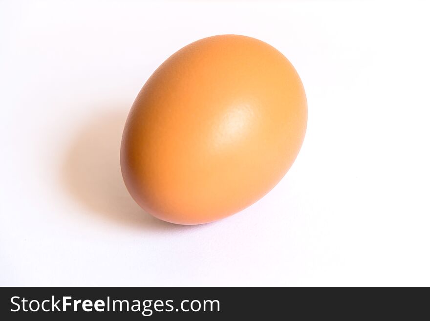A Single Brown Egg In White Background