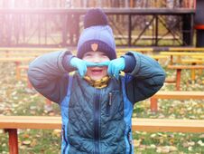 Cheerful Boy Grimaces, Autumn In The Park Royalty Free Stock Photography