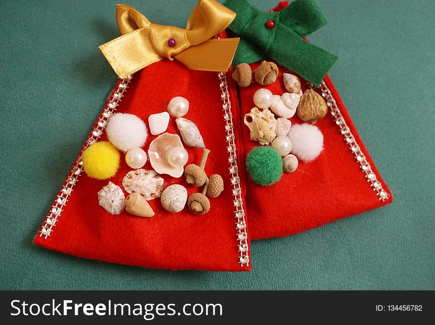 Handmade felt bags for Christmas gifts decorated with pompons, beads and natural staff like seashells, pebbles and dried fruits. Handmade felt bags for Christmas gifts decorated with pompons, beads and natural staff like seashells, pebbles and dried fruits