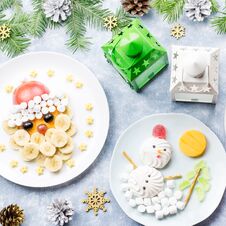Christmas Food For Children - Kiwi Christmas Tree, Marshmallow Snowman, Banana Santa Claus. Top View Royalty Free Stock Photos