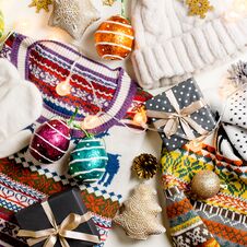 Christmas Mood Composition With Christmas Sweater, Hat, Presents And Lights. Winter Concept Flat Lay, Top View Royalty Free Stock Photography